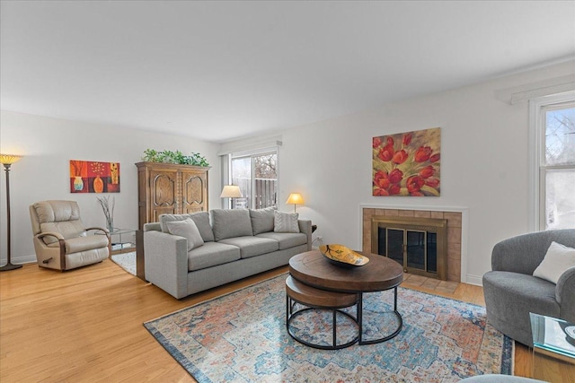 living room with a fireplace, a healthy amount of sunlight, and hardwood / wood-style floors