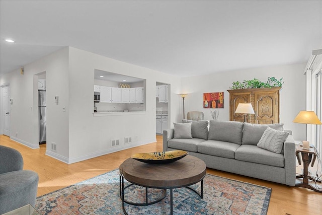 living room with light hardwood / wood-style floors