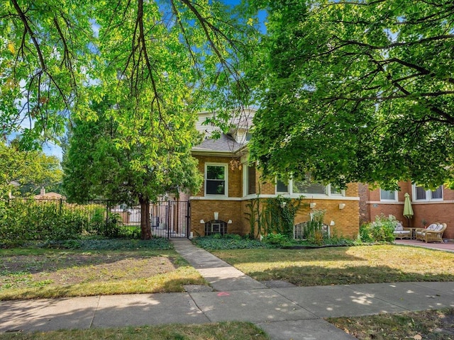 view of property hidden behind natural elements with a front yard