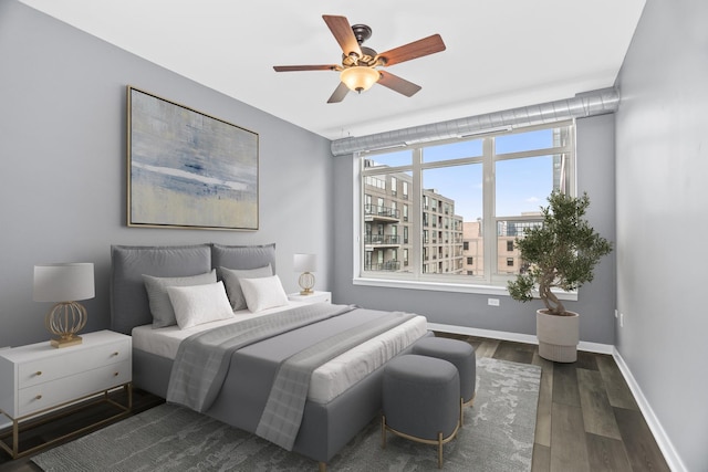 bedroom with dark wood-type flooring and ceiling fan