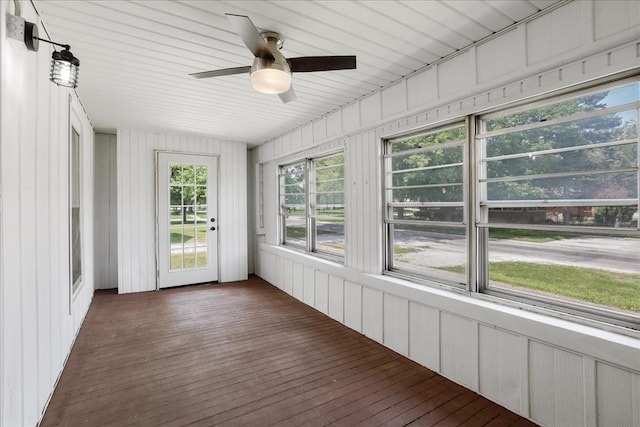 unfurnished sunroom with ceiling fan