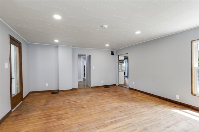 unfurnished room with french doors and light wood-type flooring