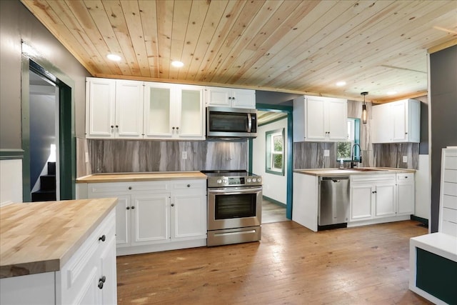 kitchen featuring white cabinetry, wooden counters, pendant lighting, wood ceiling, and appliances with stainless steel finishes