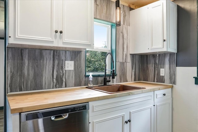 kitchen featuring dishwasher, white cabinetry, and sink