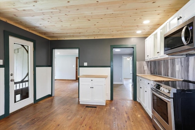 kitchen featuring white cabinetry, light wood-type flooring, wood ceiling, and appliances with stainless steel finishes