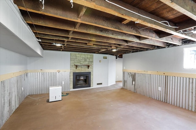 basement featuring a stone fireplace