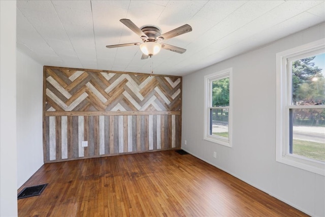 empty room with wood-type flooring and ceiling fan