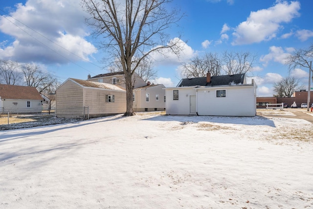 view of snow covered back of property