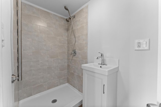 bathroom featuring a tile shower and vanity