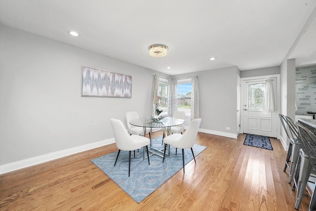 dining room with light hardwood / wood-style floors and a wealth of natural light