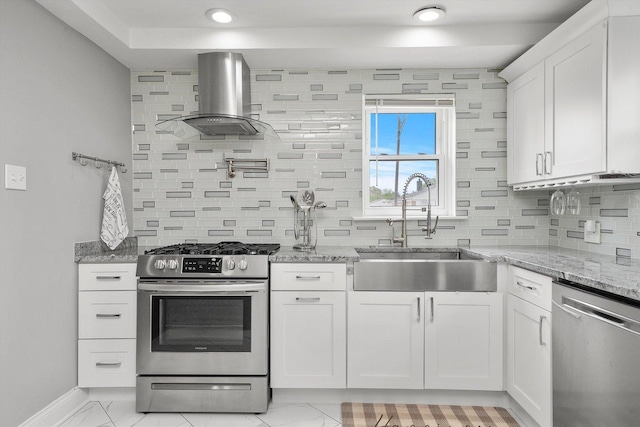 kitchen featuring white cabinets, sink, light stone counters, stainless steel appliances, and extractor fan