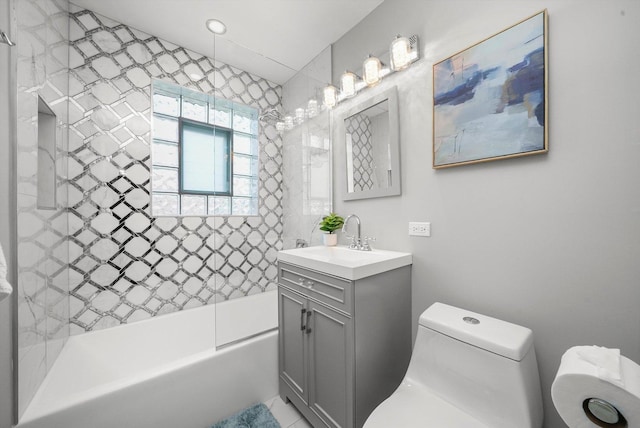 full bathroom with toilet, vanity, and tiled shower / bath