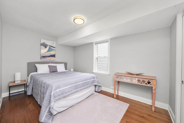 bedroom with dark wood-type flooring