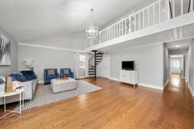 living room with hardwood / wood-style floors, high vaulted ceiling, and an inviting chandelier