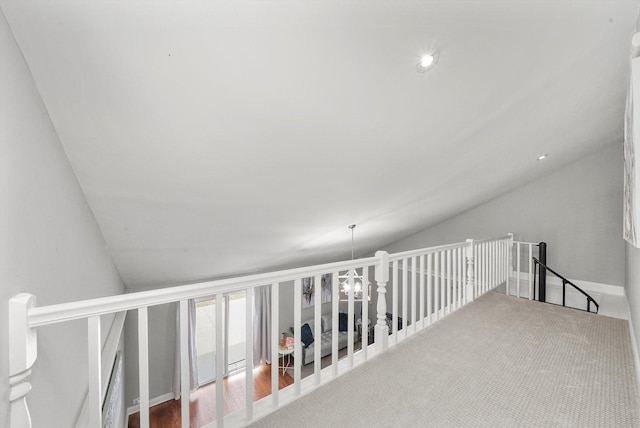 corridor featuring carpet floors and lofted ceiling