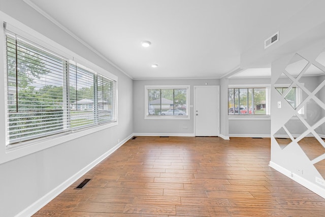 interior space with crown molding and hardwood / wood-style floors