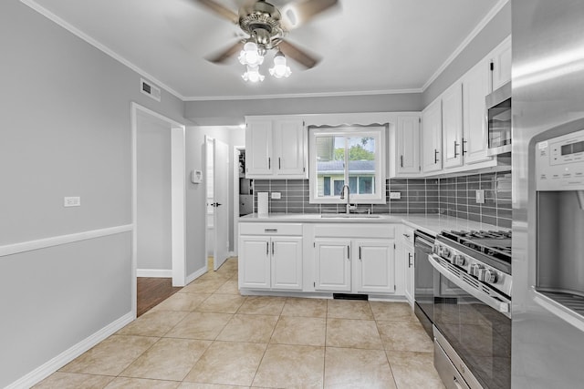 kitchen featuring light tile patterned flooring, white cabinetry, sink, and appliances with stainless steel finishes