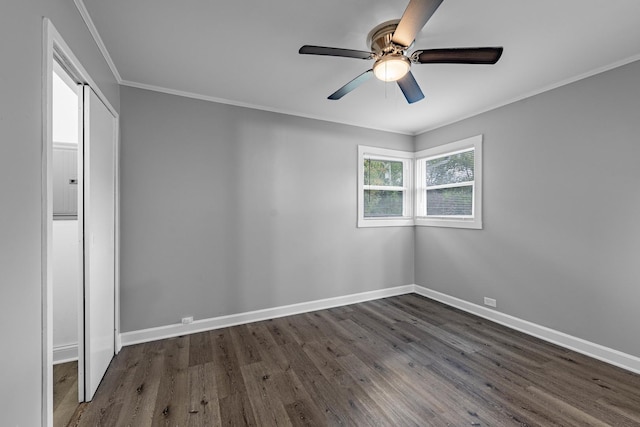 unfurnished room with dark hardwood / wood-style flooring, ceiling fan, and ornamental molding