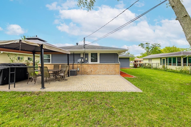 rear view of house featuring a yard and a patio