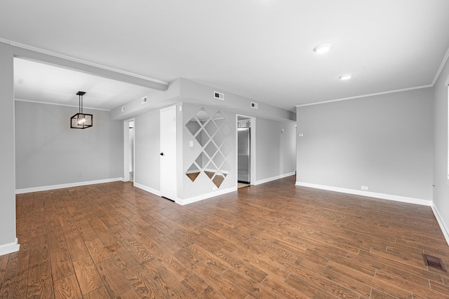 unfurnished living room featuring dark hardwood / wood-style flooring and ornamental molding