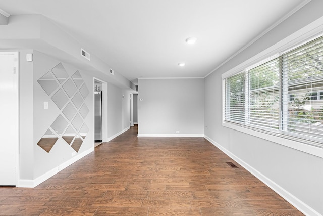 empty room featuring crown molding and dark hardwood / wood-style floors