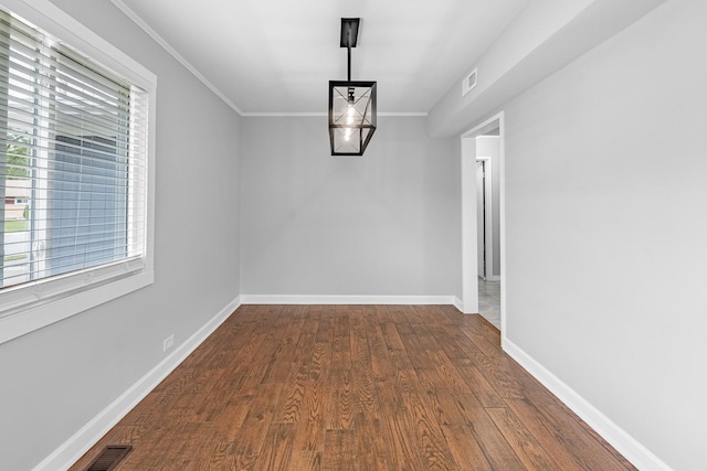 unfurnished dining area with hardwood / wood-style floors and crown molding