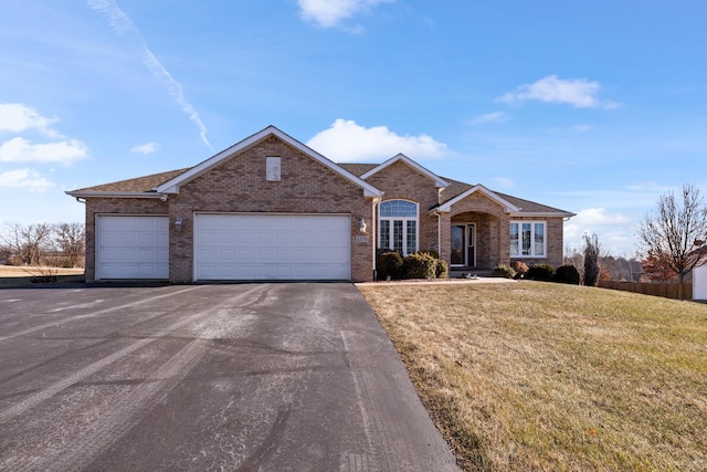 view of front of house featuring a front yard and a garage