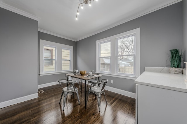 dining area with dark hardwood / wood-style floors and crown molding