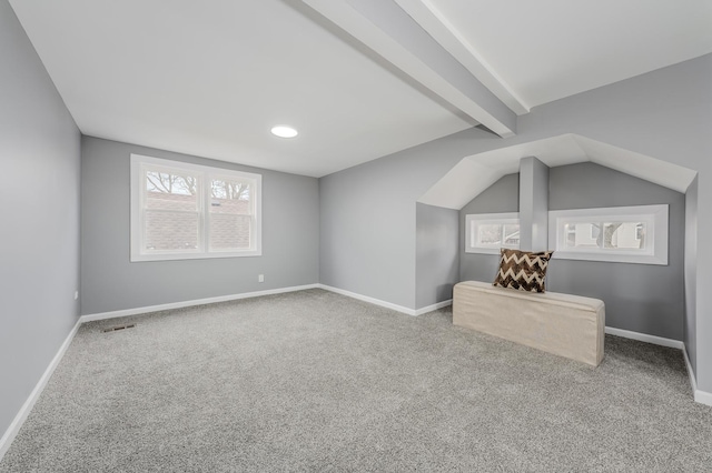 additional living space featuring carpet and lofted ceiling with beams