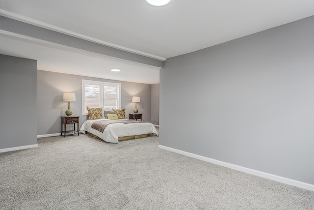 bedroom featuring carpet flooring and beam ceiling