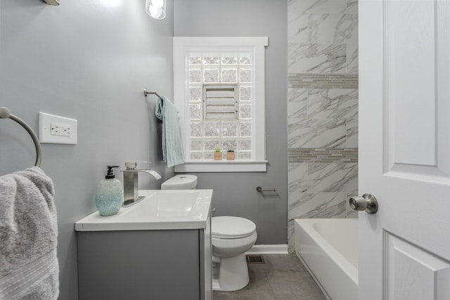 full bathroom with vanity, tiled shower / bath combo, and toilet