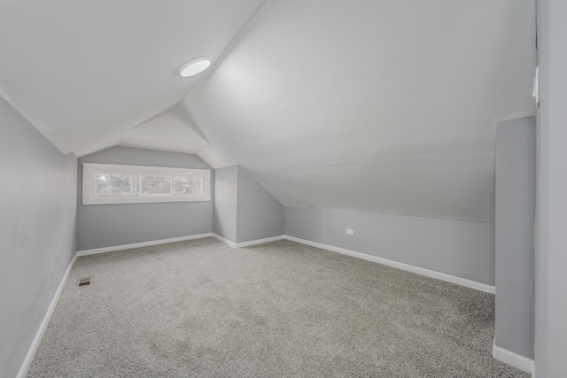 bonus room with carpet and lofted ceiling