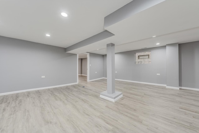 basement with light hardwood / wood-style floors