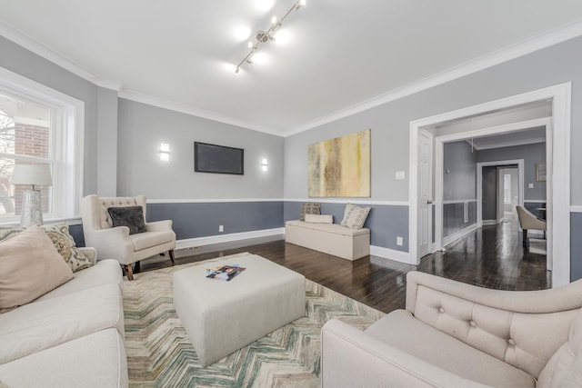 living room with crown molding, hardwood / wood-style floors, and rail lighting