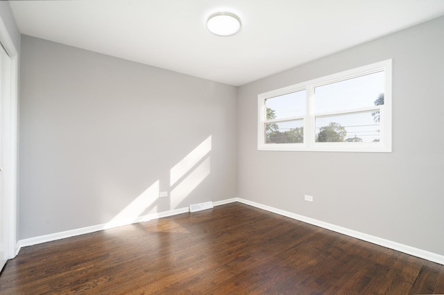 spare room with wood-type flooring