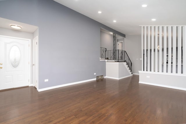 unfurnished living room with dark wood-type flooring