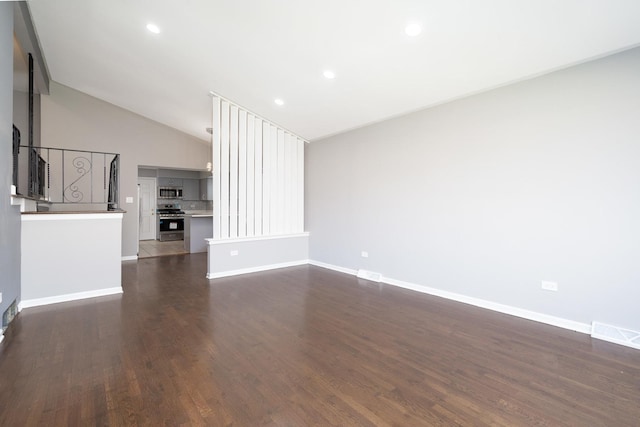 unfurnished living room with dark wood-type flooring and lofted ceiling