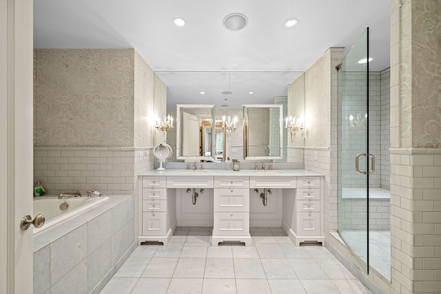 bathroom with tile patterned floors, vanity, and separate shower and tub