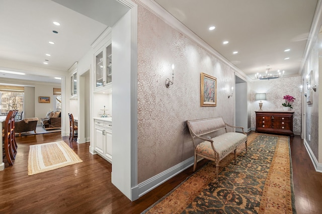 hall featuring ornamental molding, built in features, and dark hardwood / wood-style flooring