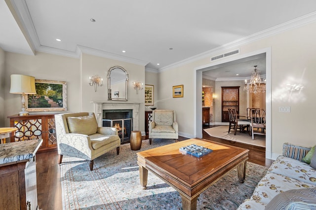 living room with a chandelier, crown molding, and wood-type flooring