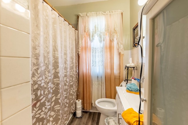 bathroom with toilet and hardwood / wood-style flooring