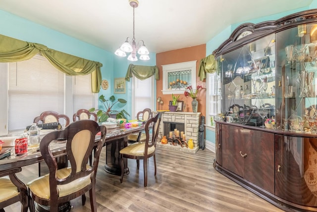 dining area with hardwood / wood-style flooring and a chandelier