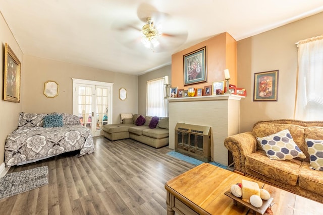 living room with french doors, hardwood / wood-style floors, a fireplace, and ceiling fan