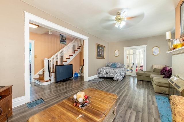 living room featuring french doors, ceiling fan, and dark wood-type flooring