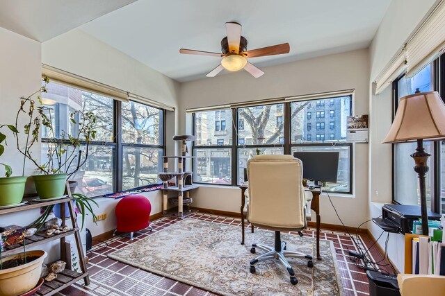 office area featuring ceiling fan and dark tile patterned floors