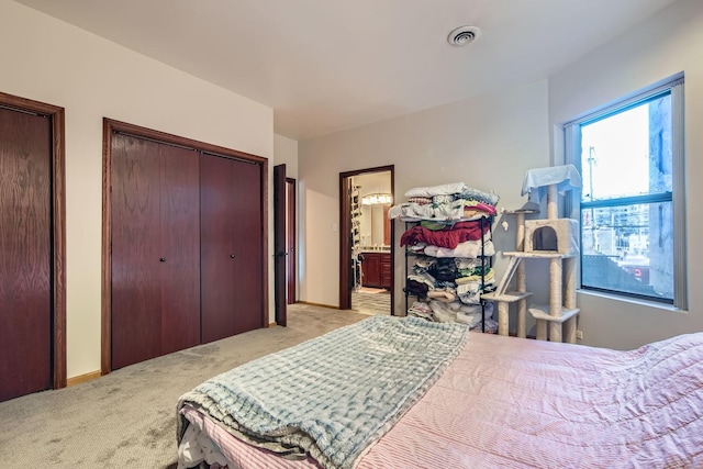 carpeted bedroom featuring connected bathroom