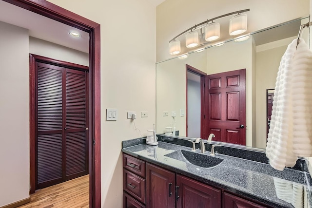 bathroom with vanity and wood-type flooring