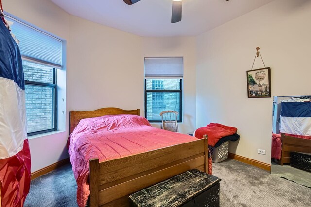 bedroom featuring carpet, ceiling fan, and multiple windows