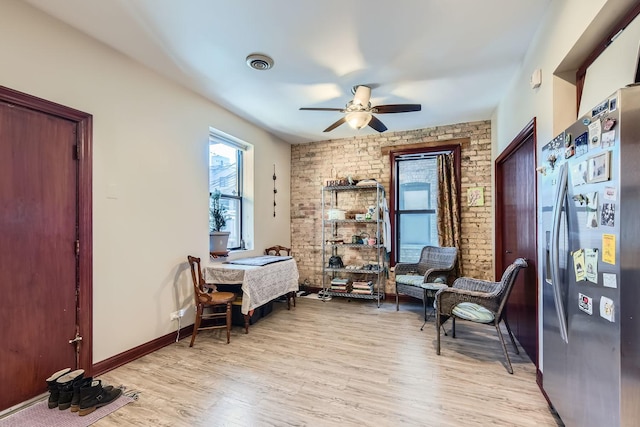 living area featuring light wood-type flooring and ceiling fan