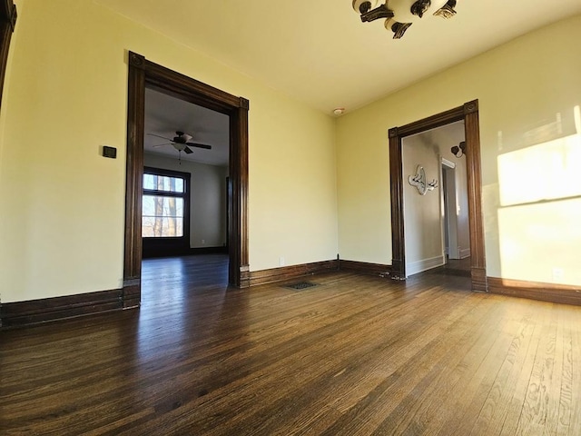 spare room featuring ceiling fan and dark hardwood / wood-style floors